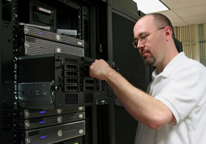 Network administrator working on server hardware