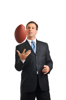 Sports management professional holding a football