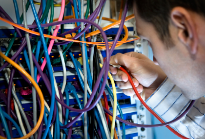 Computer network technician working with network cables